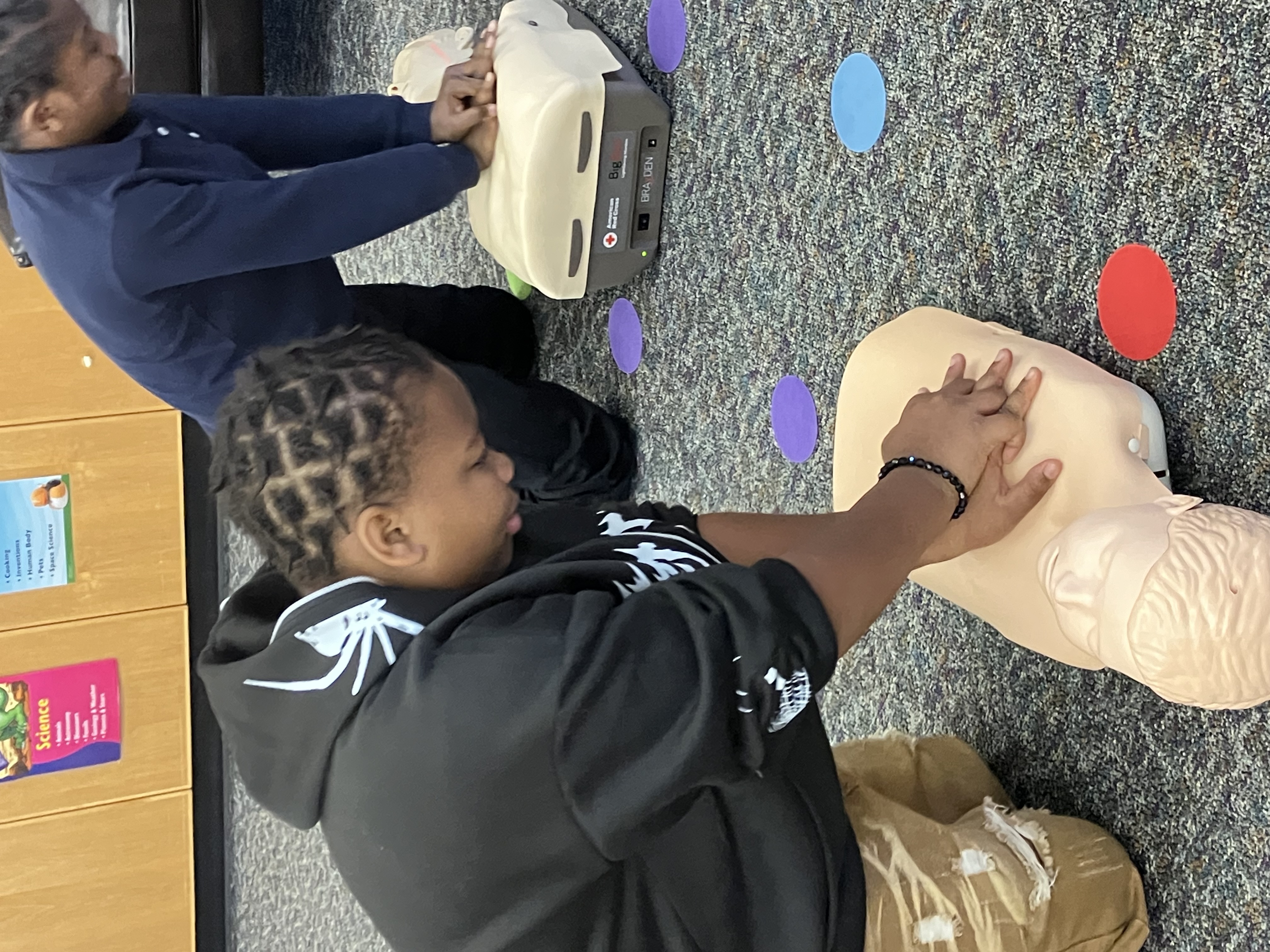Students practicing CPR and first aid at NWBCC after school program