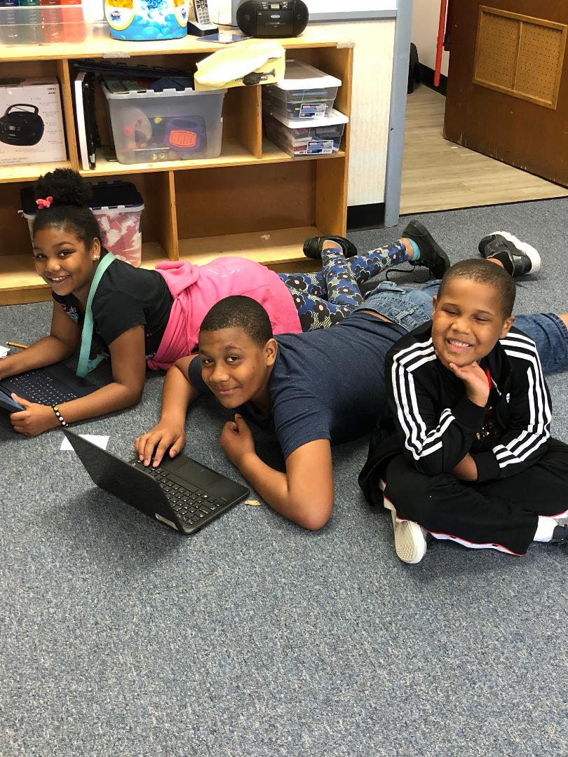 Children learning on laptops at Munchkinland educational program