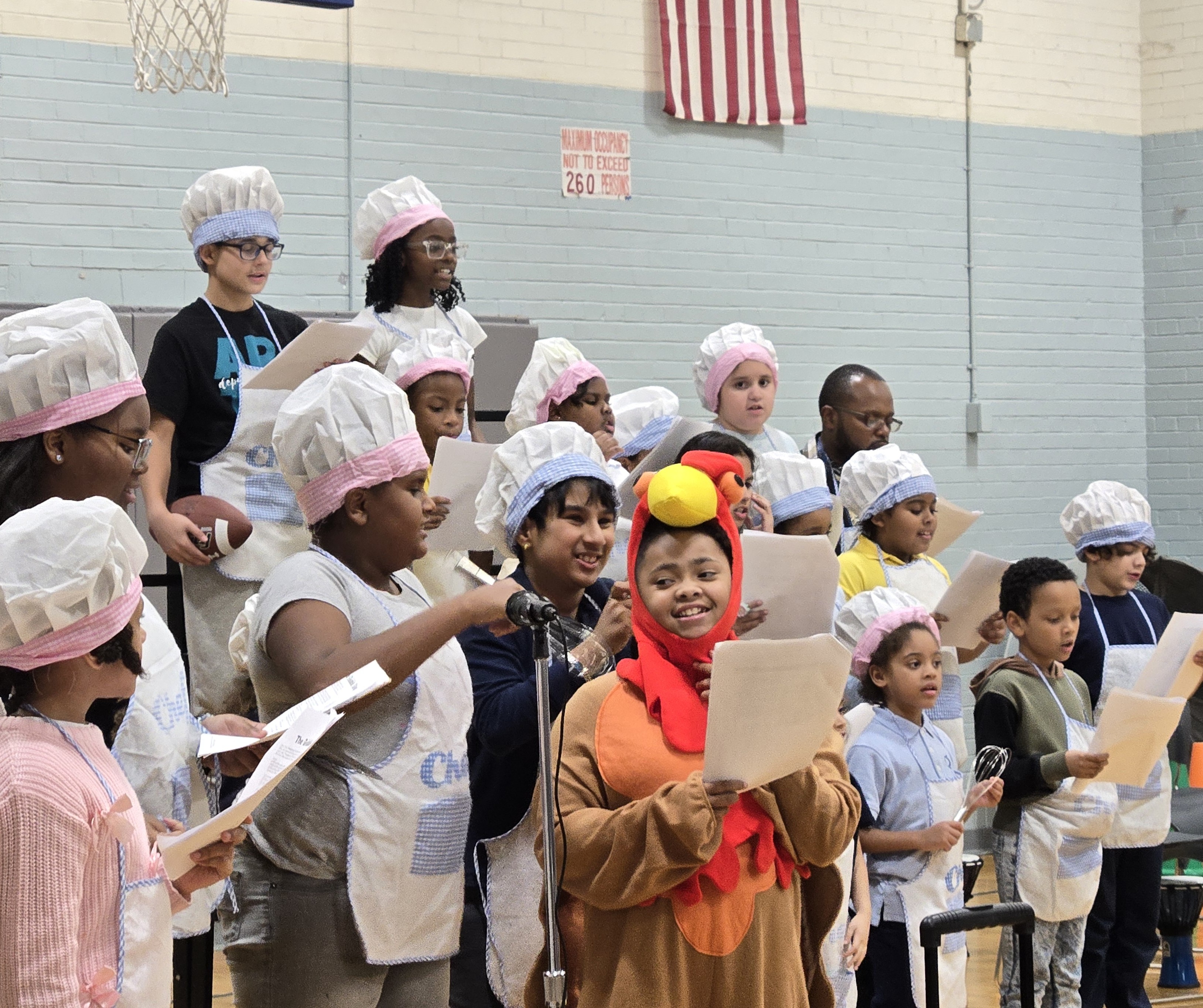 Youth performing Thanksgiving play in chef costumes at NWBCC